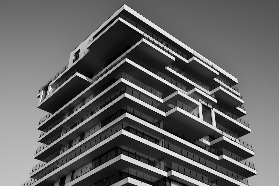 Free A striking black and white photo of a modern high-rise building with unique geometric designs. Stock Photo