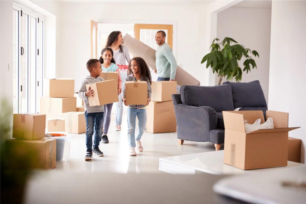 A family carrying boxes in a room