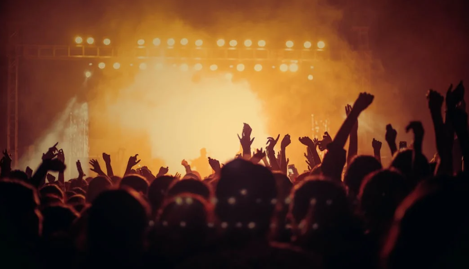 A crowd of people with their hands up in the air AI-generated content may be incorrect.