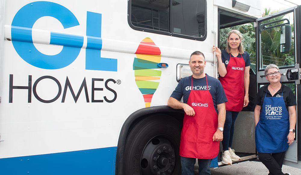 GL Homes leaders, including Misha Ezratti serve food through mobile meal service.