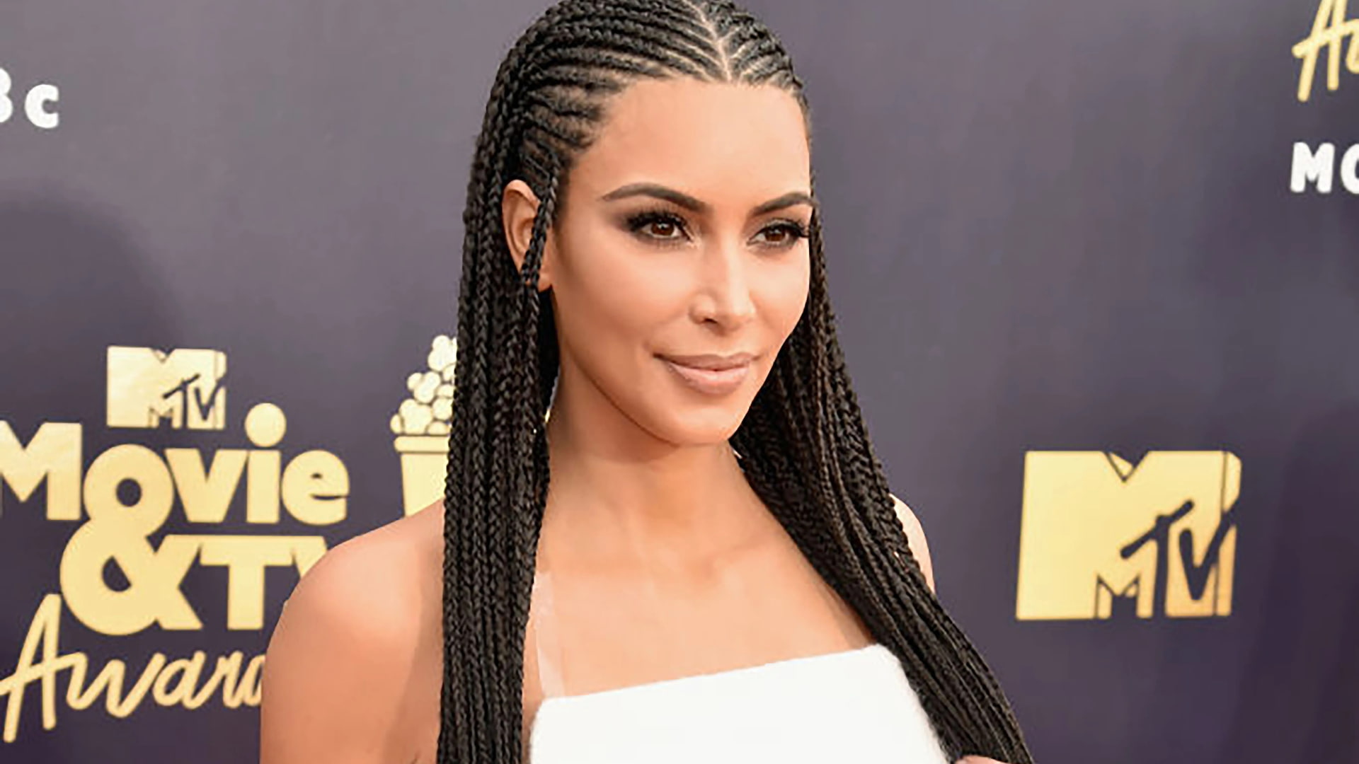 Kim Kardashian with long braids posing at the MTV Movie and TV Awards show event