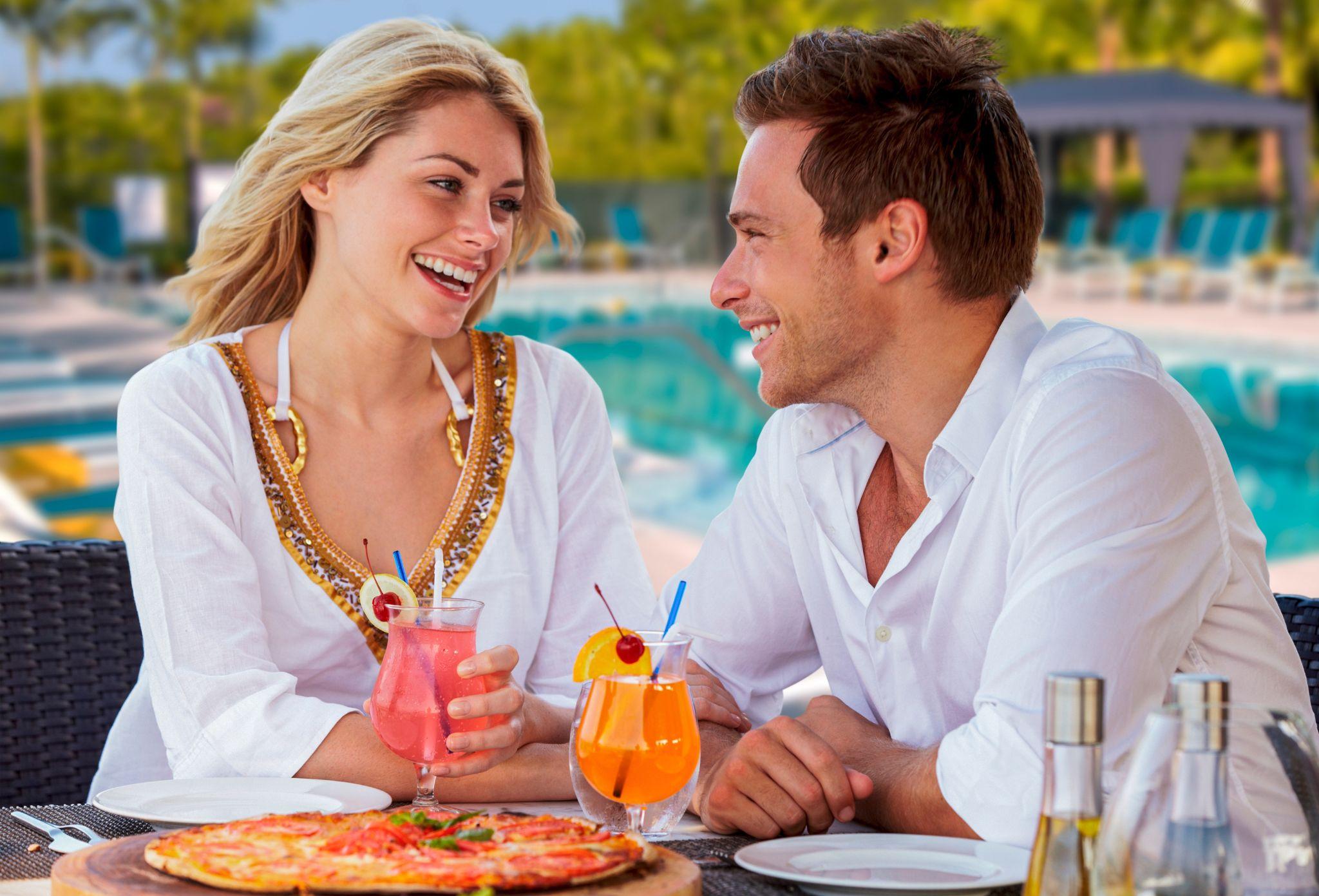 A GL Homes couple enjoys poolside amenities inspired by Itzhak Ezratti's community values.