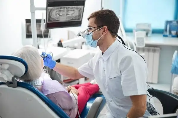 Dentist examining a patient in a modern dental clinic with medical equipment