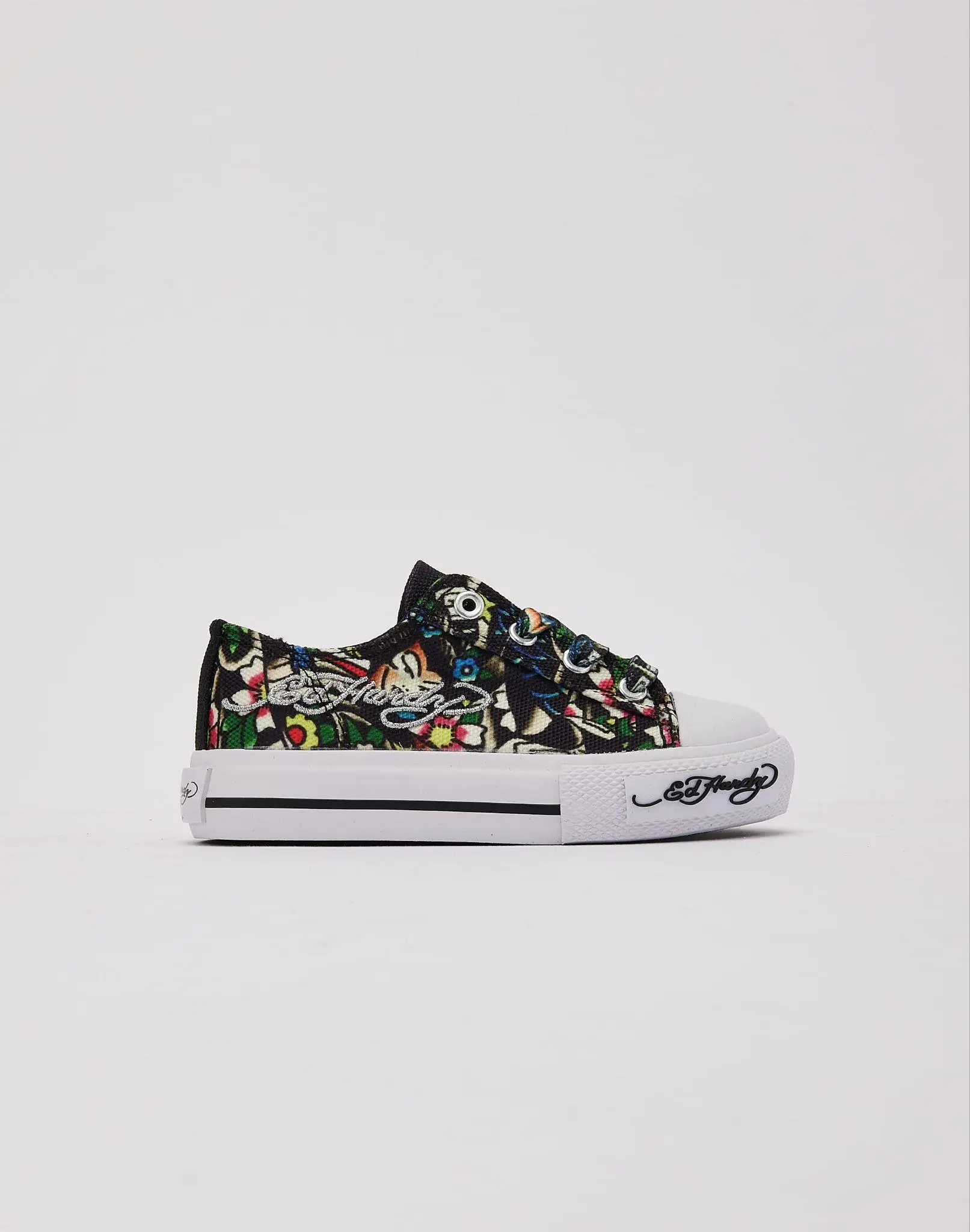 Colorful patterned sneakers with white rubber sole against plain background