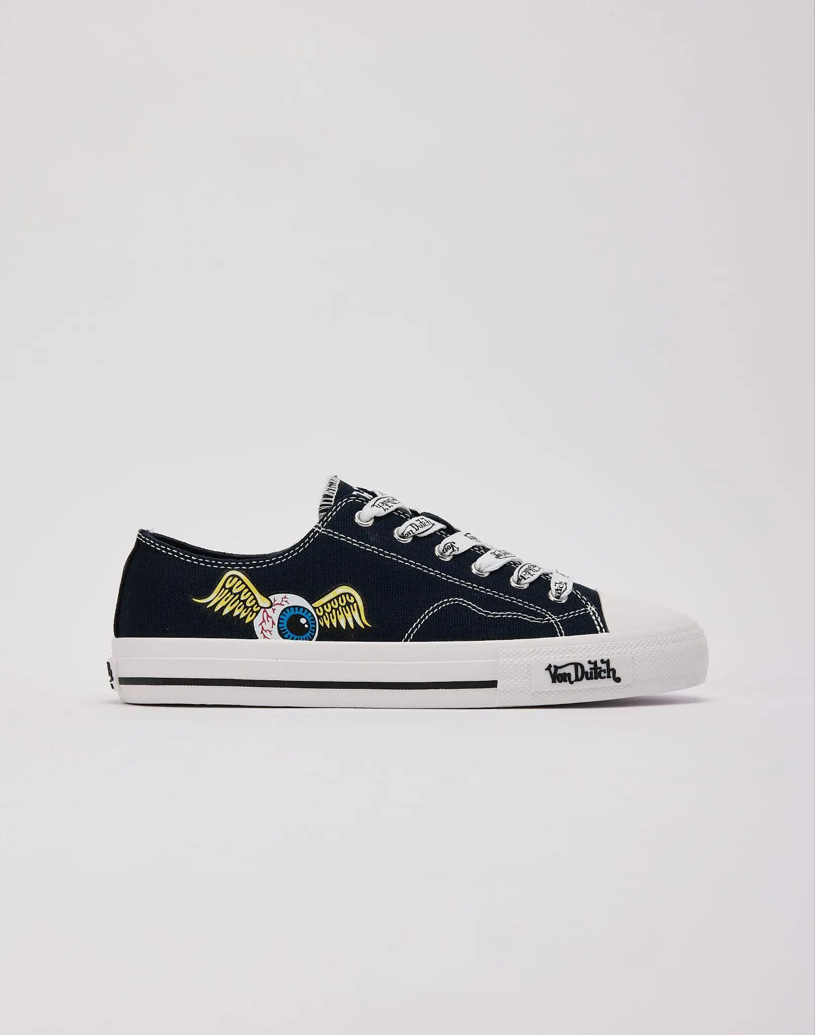 Black canvas sneaker with white sole featuring winged eye graphic against plain background