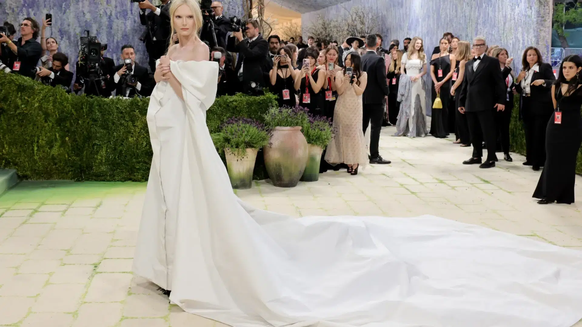 Alex Consani in a versace black gown with white jacket