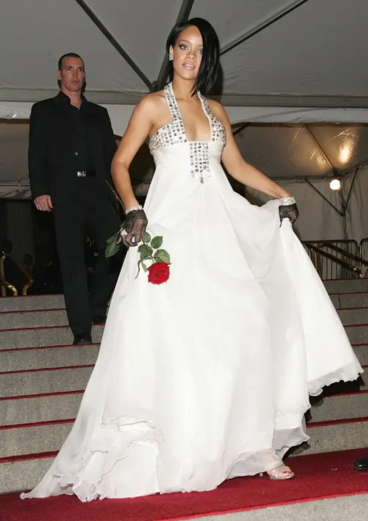 Rihanna at her Met Gala debut in a white Georges Chakra gown with lace gloves.