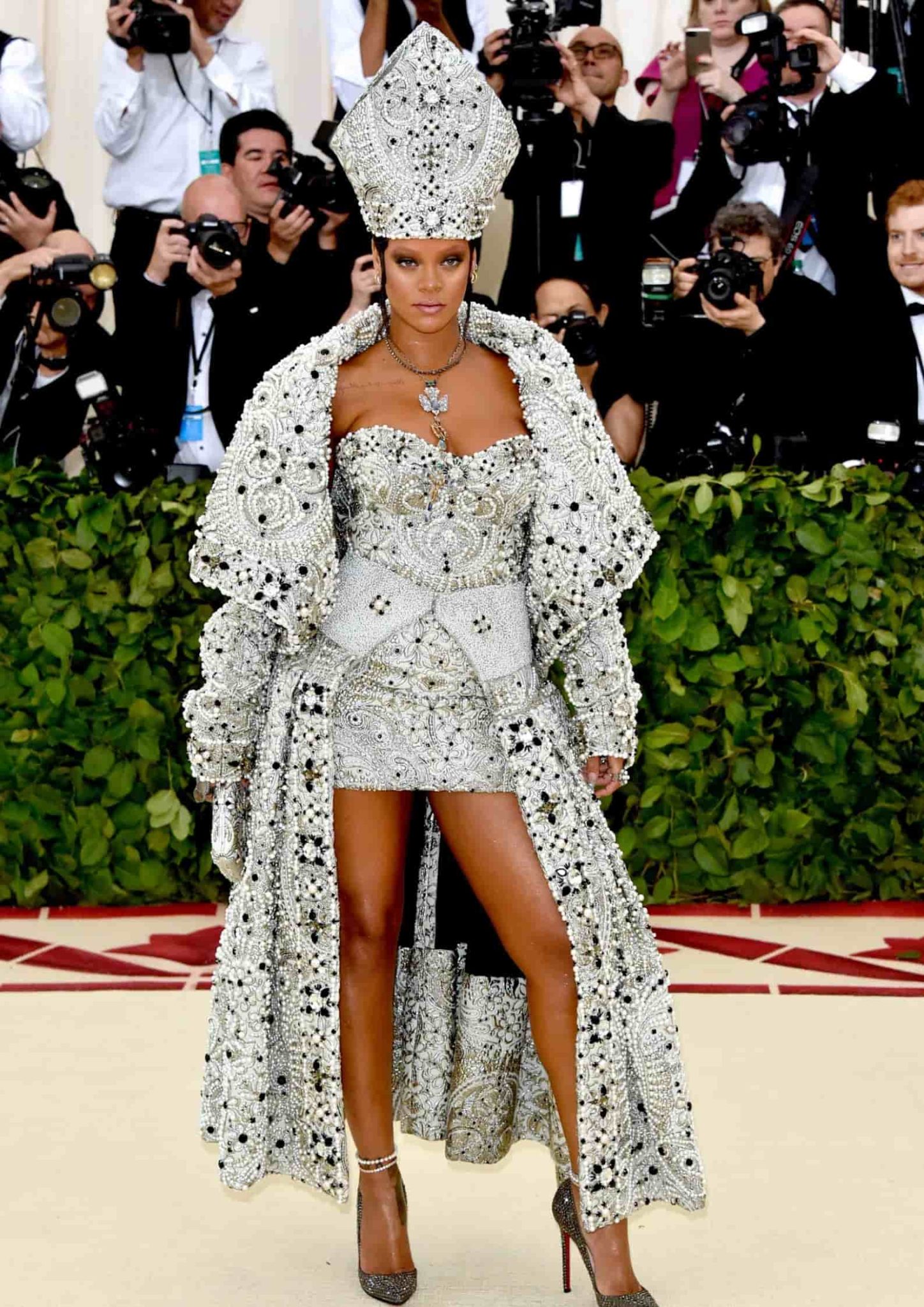 Rihanna at the Met Gala in a Maison Margiela papal cloak and pearl mitre.