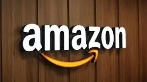 Amazon logo with curved arrow on wooden textured background
