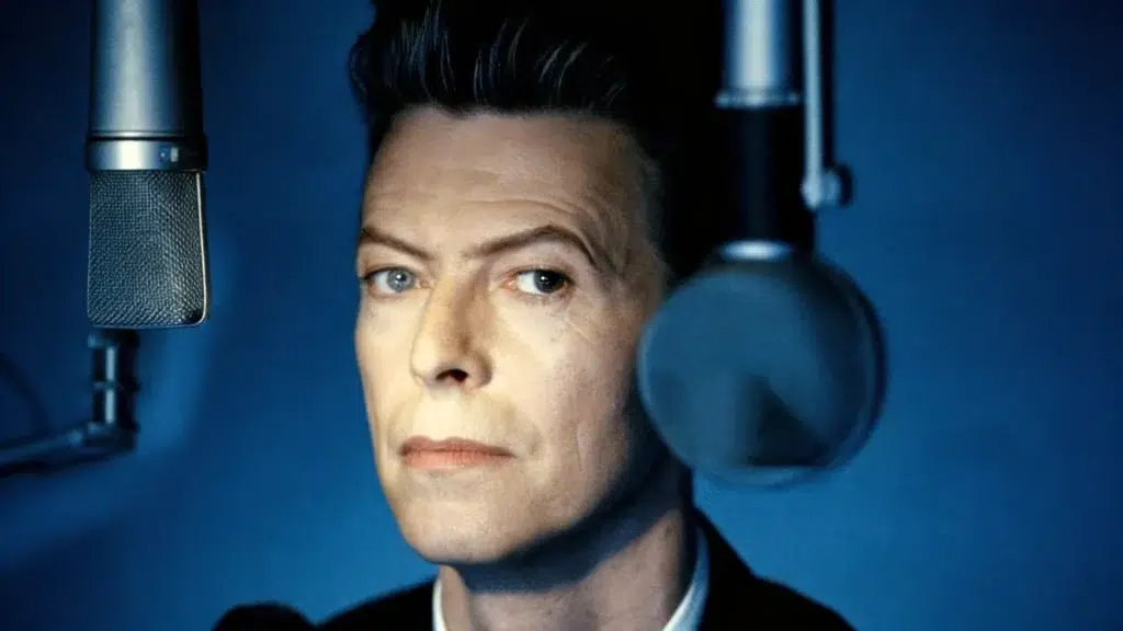 david bowie in recording studio between microphones, showing distinct, uneven pupils, highlighting his facial features