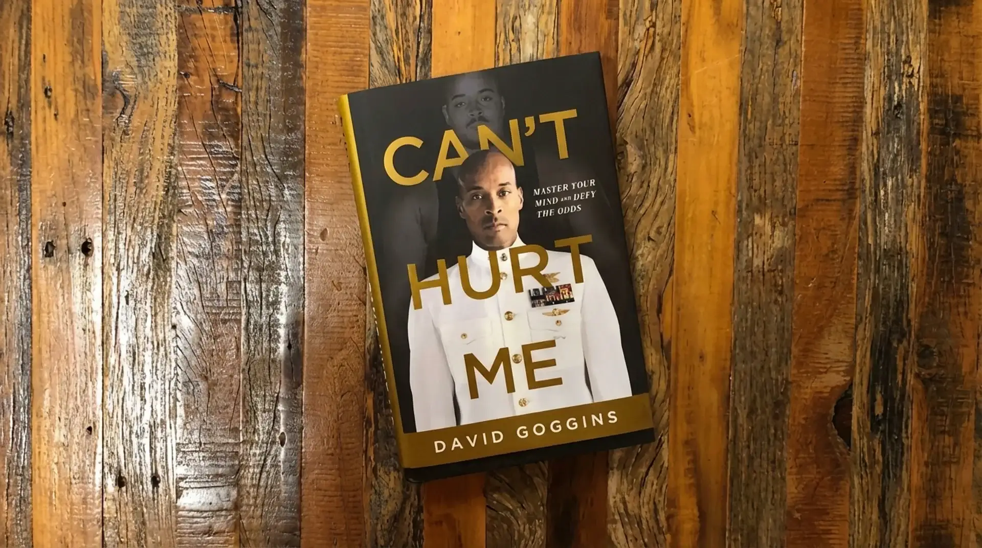 david goggins can’t hurt me book placed on a wooden surface, showing cover with author portrait and bold title