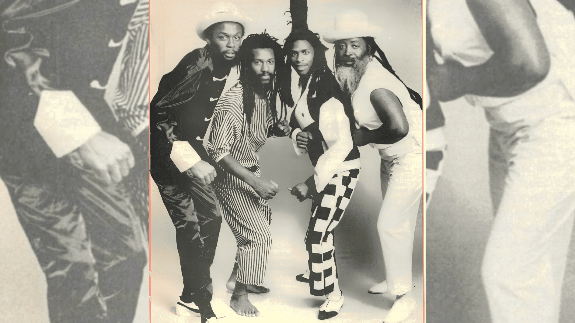 four reggae performers in vintage black-and-white portrait wearing patterned stage outfits.