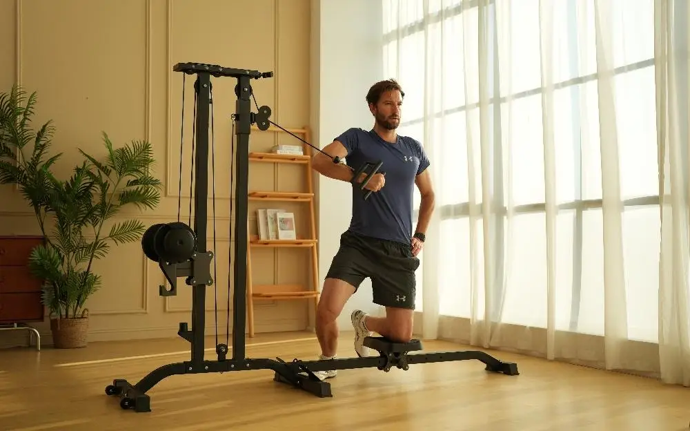 Man exercising with cable machine in brightly lit home gym with wooden floors