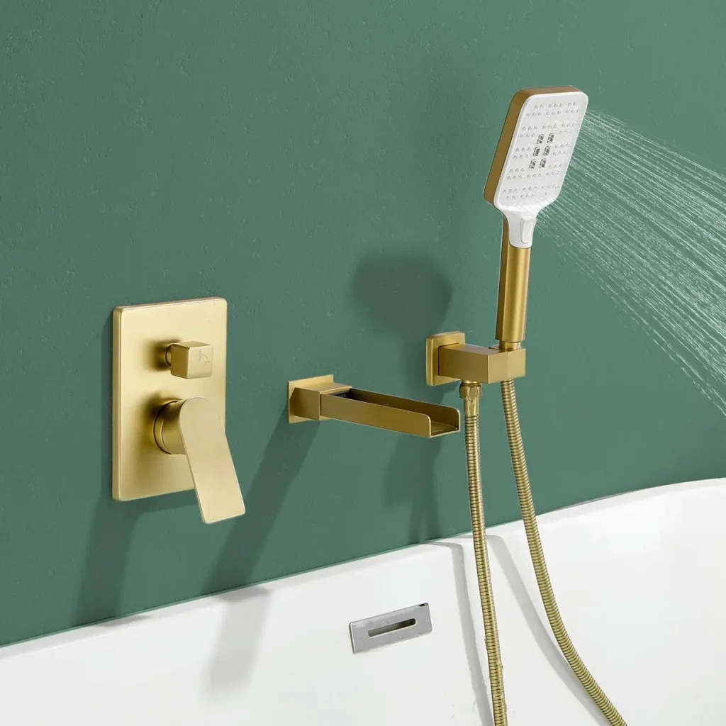 Gold bathroom fixtures with handheld shower and faucet on green wall above white tub