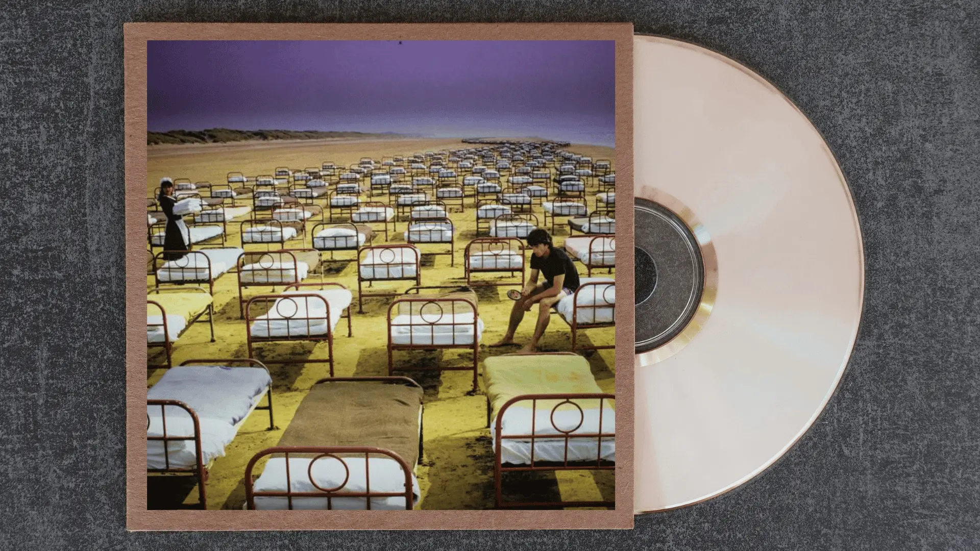 pink floyd a momentary lapse of reason album cover with rows of hospital beds stretching across an empty beach