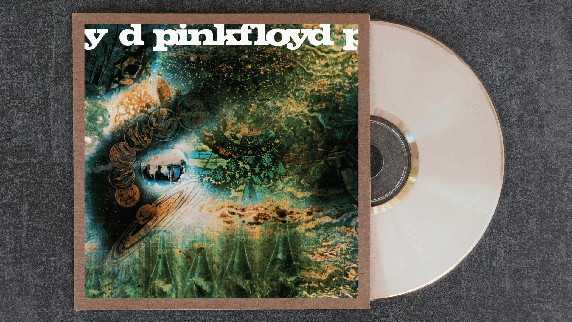 pink floyd a saucerful of secrets album cover with a dense psychedelic collage of planets and cosmic imagery in green and gold
