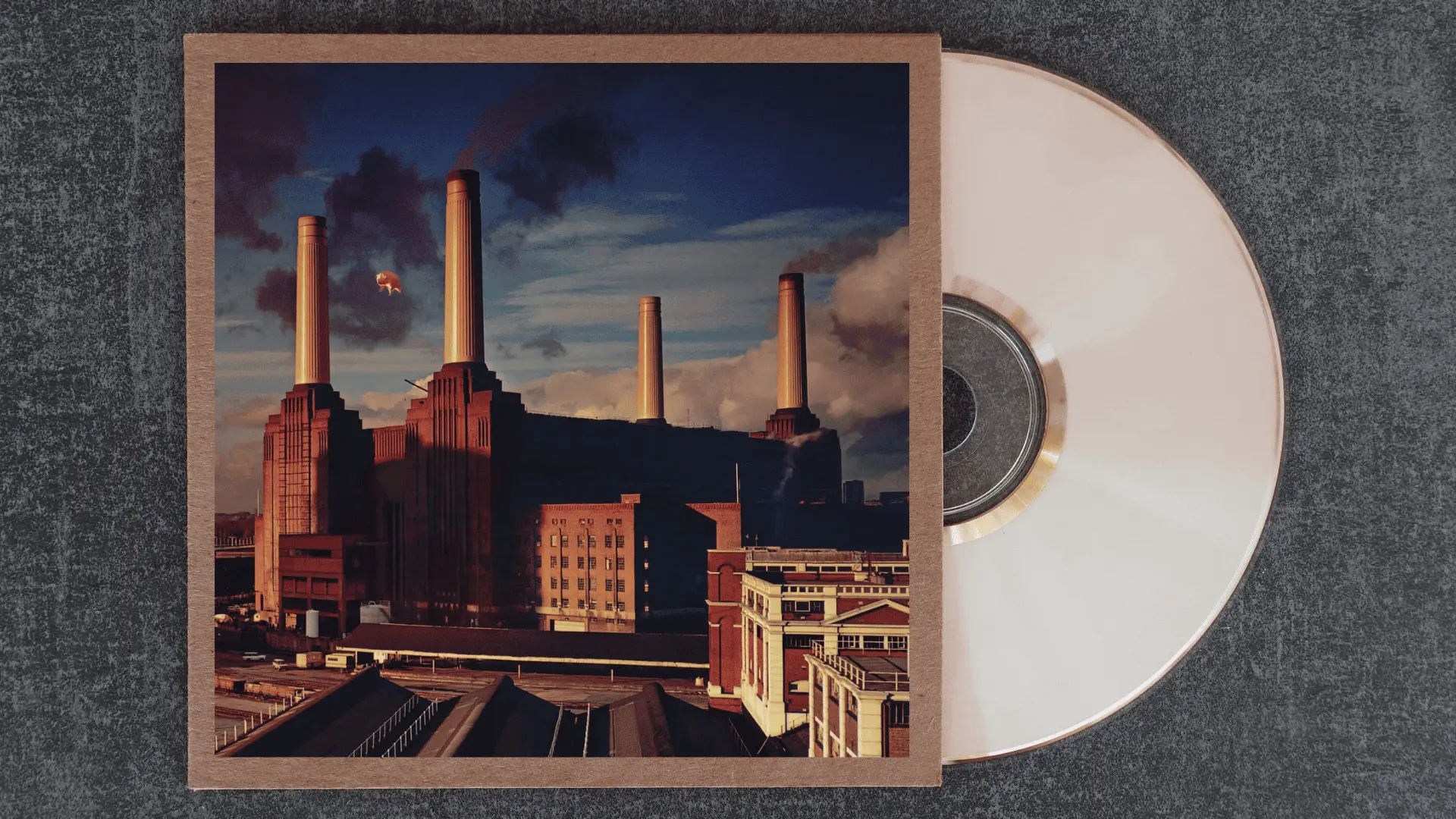 pink floyd animals album cover with an inflatable pig floating above battersea power station in london
