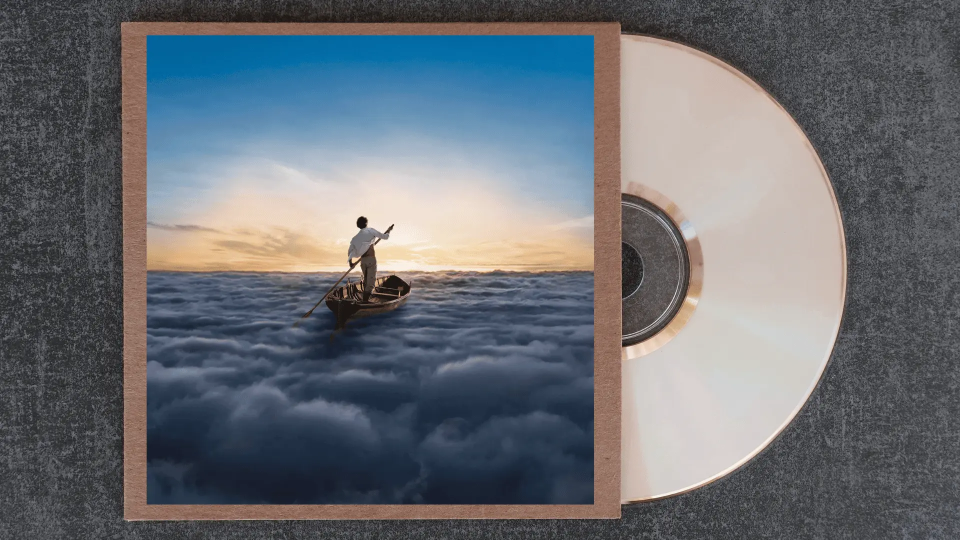 pink floyd the endless river album cover showing a lone figure rowing a wooden boat above a sea of clouds at sunset