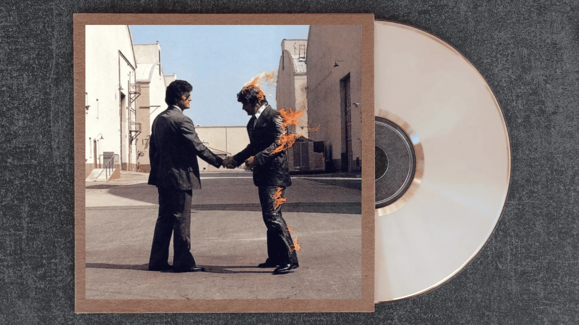 pink floyd wish you were here album cover showing two suited men shaking hands while one is engulfed in flames