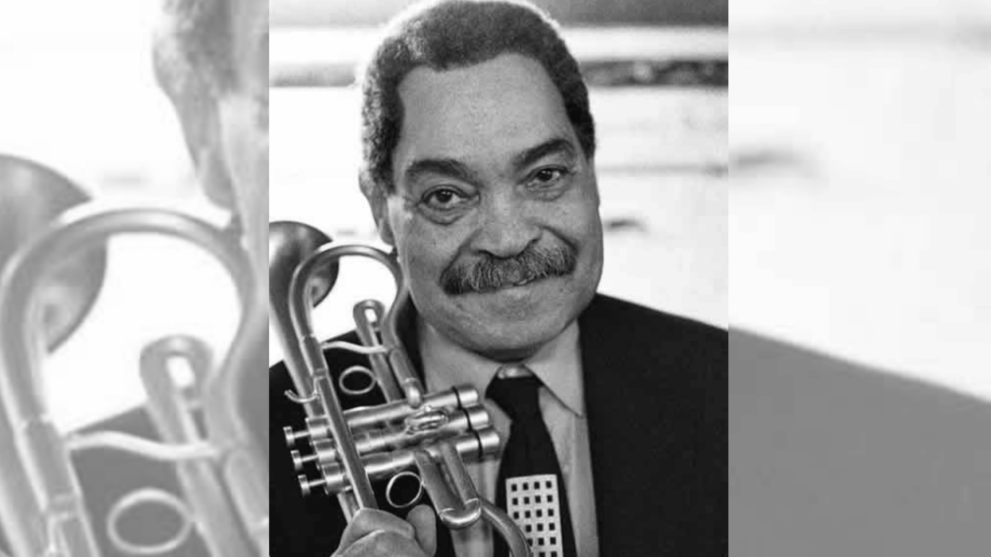 art farmer smiling while holding flugelhorn in a relaxed hard-bop jazz portrait