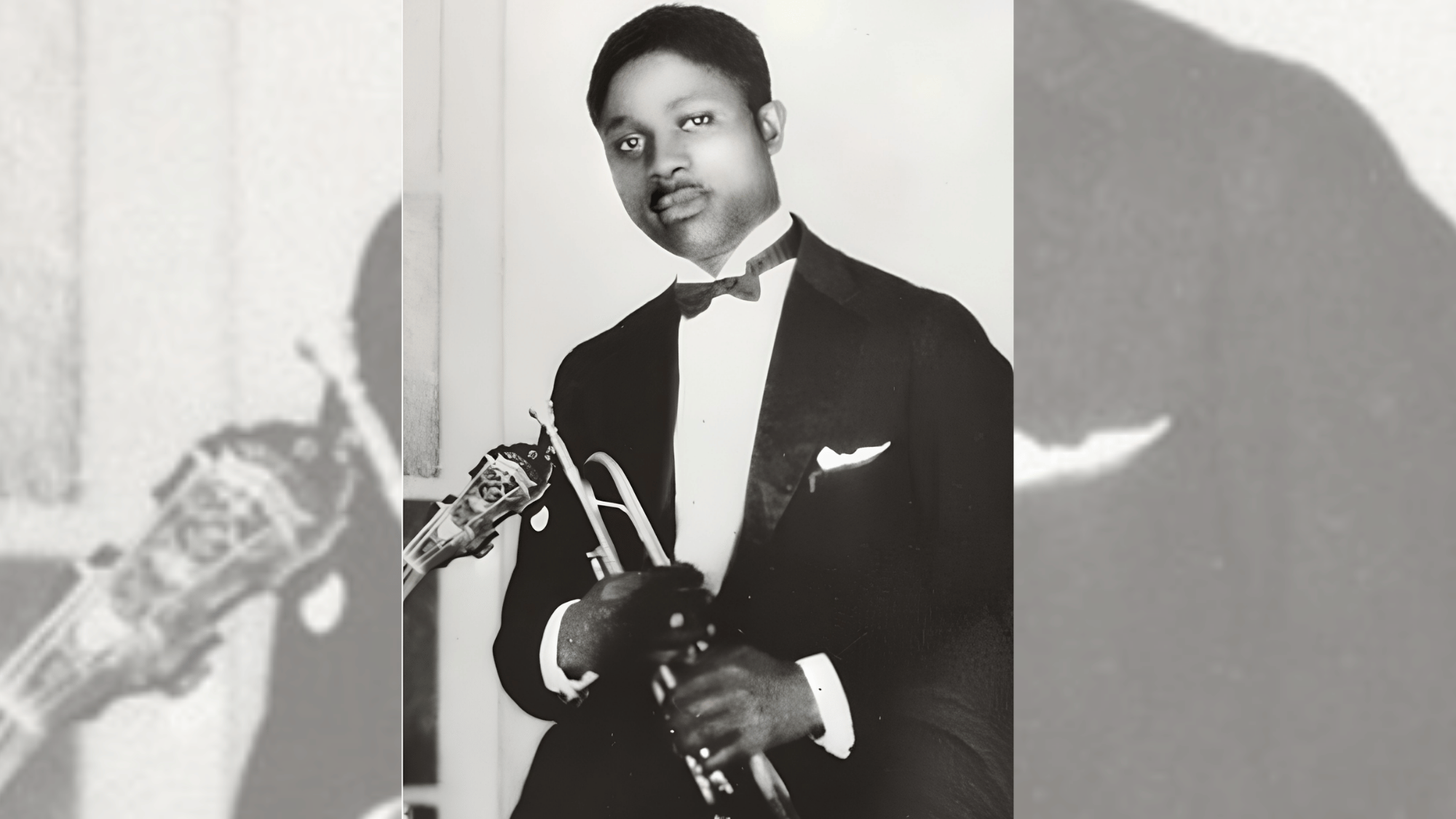 bubber miley holding a trumpet in a formal portrait from the early jazz period