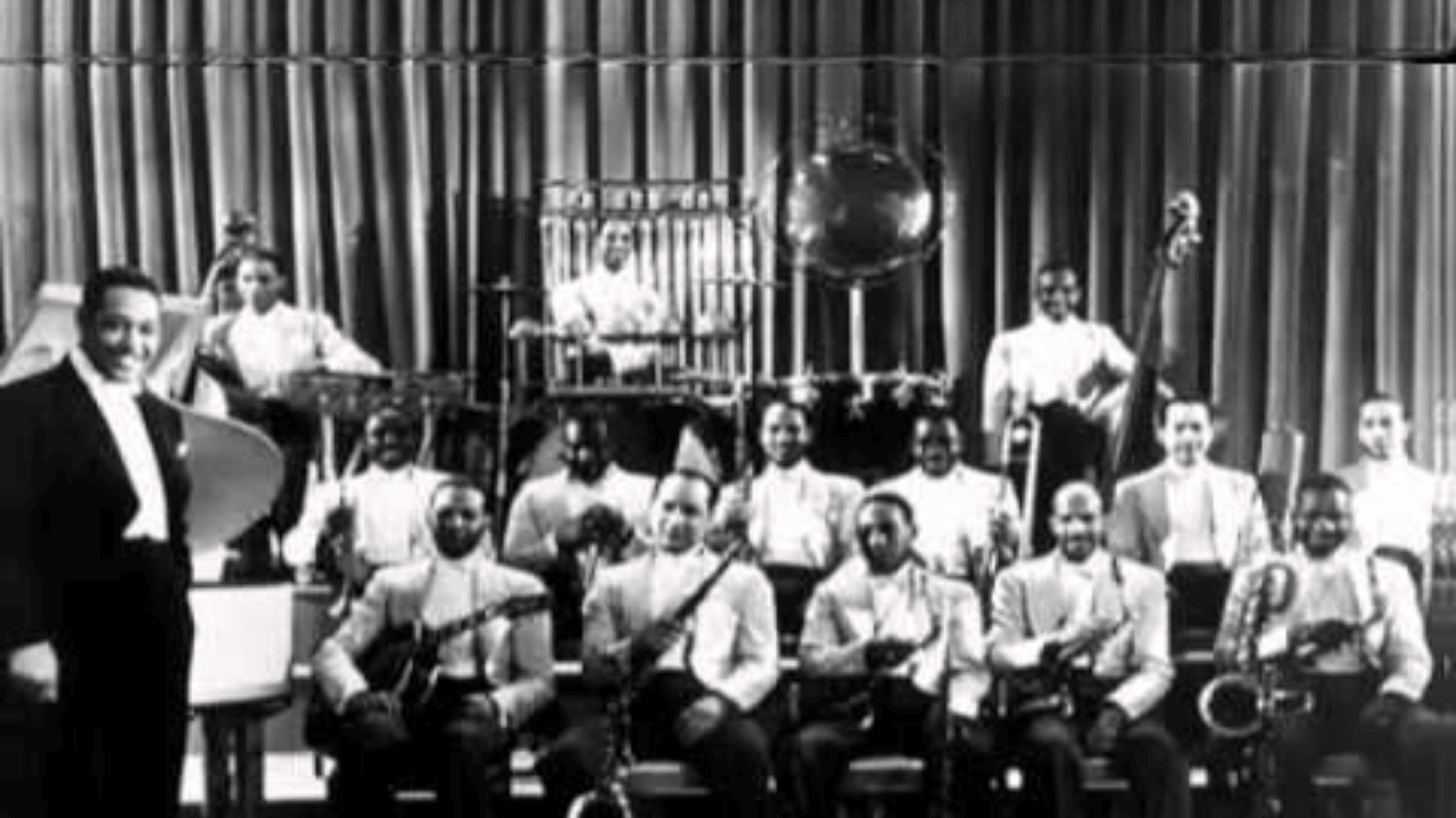 Duke Ellington Caravan era full big band orchestra on stage black and white archival group photograph