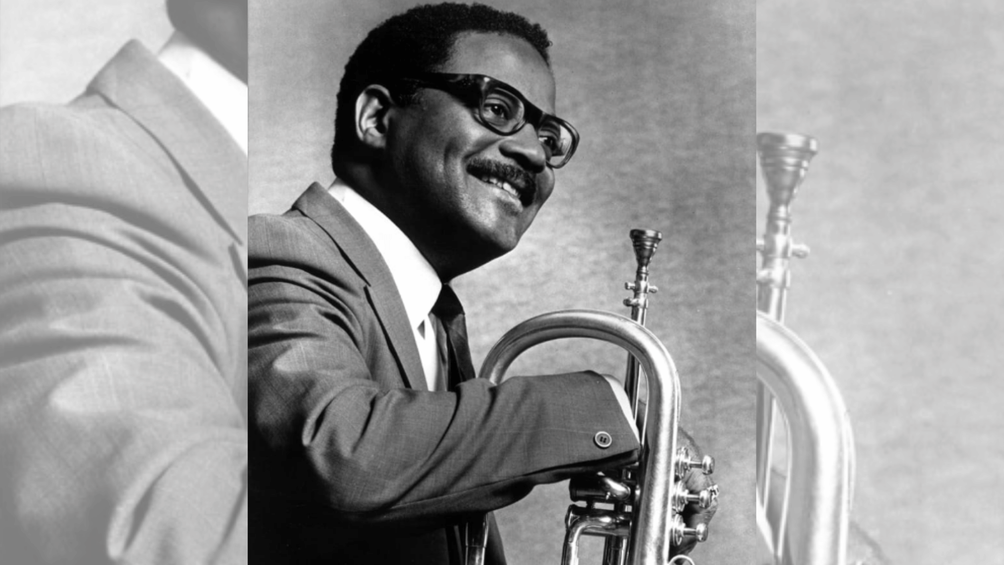 clark terry posing with flugelhorn in a timeless black and white jazz portrait