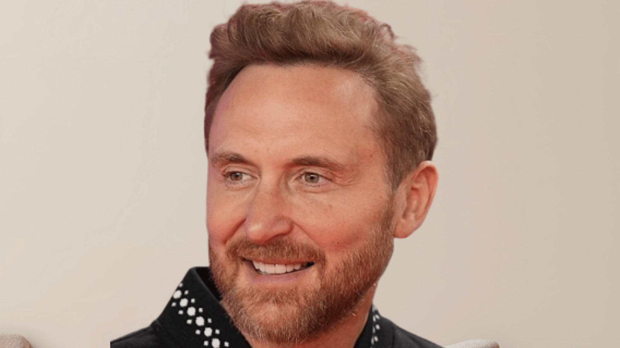 David Guetta performing a DJ set at a major festival representing his decade of commercial house music dominance.