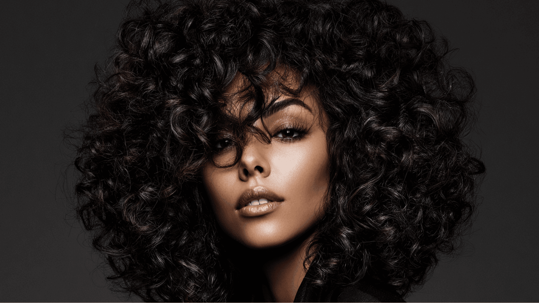 deep curly sew-in with bold defined curls and voluminous texture