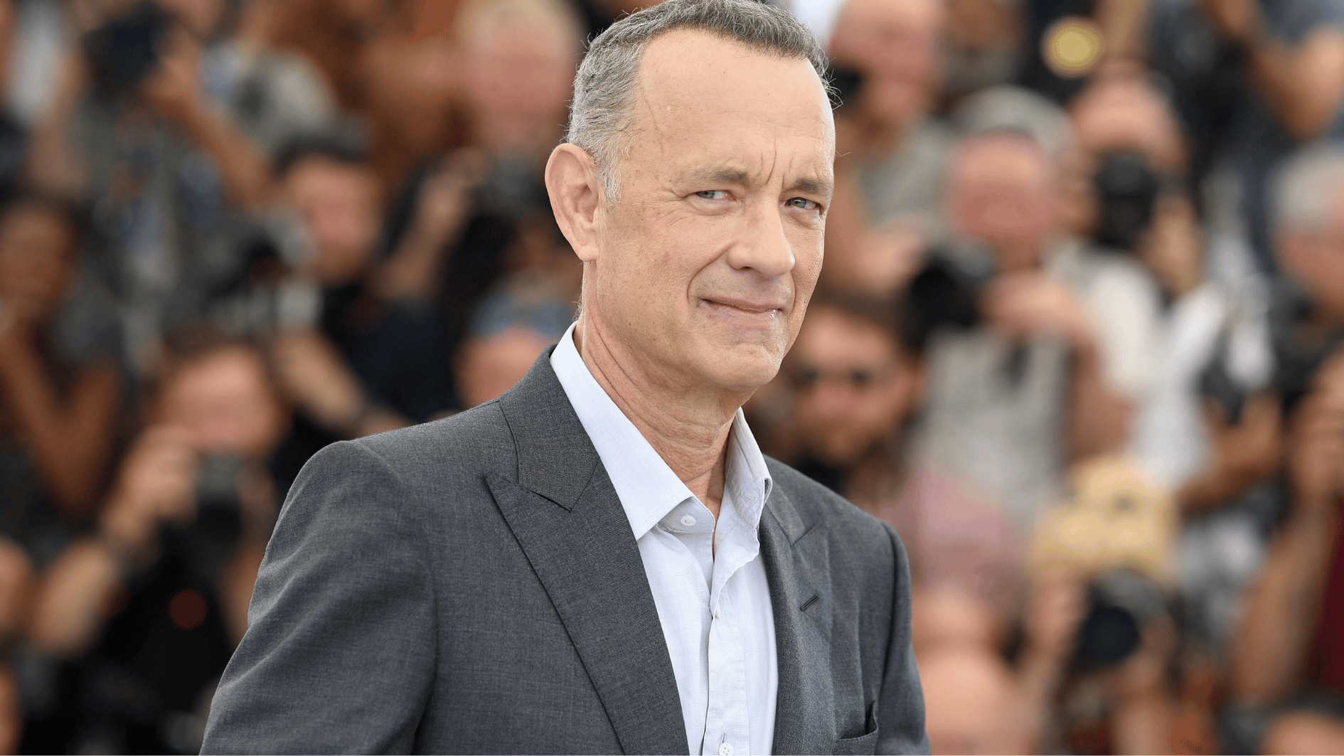 tom hanks posing at a public event, highlighting his enduring success and respected Hollywood career image