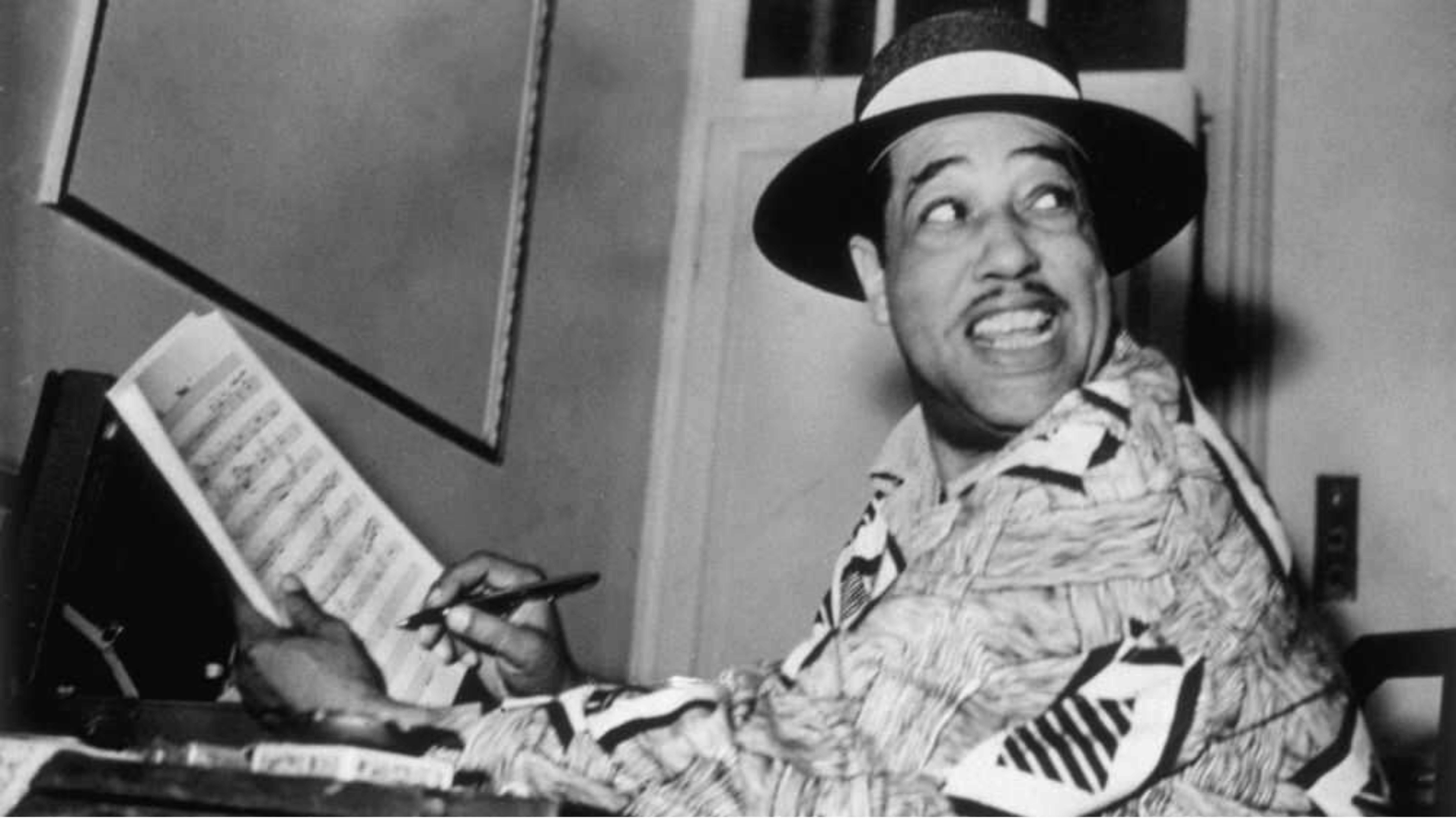 Duke Ellington composing In a Sentimental Mood at piano with sheet music and pen black and white photograph