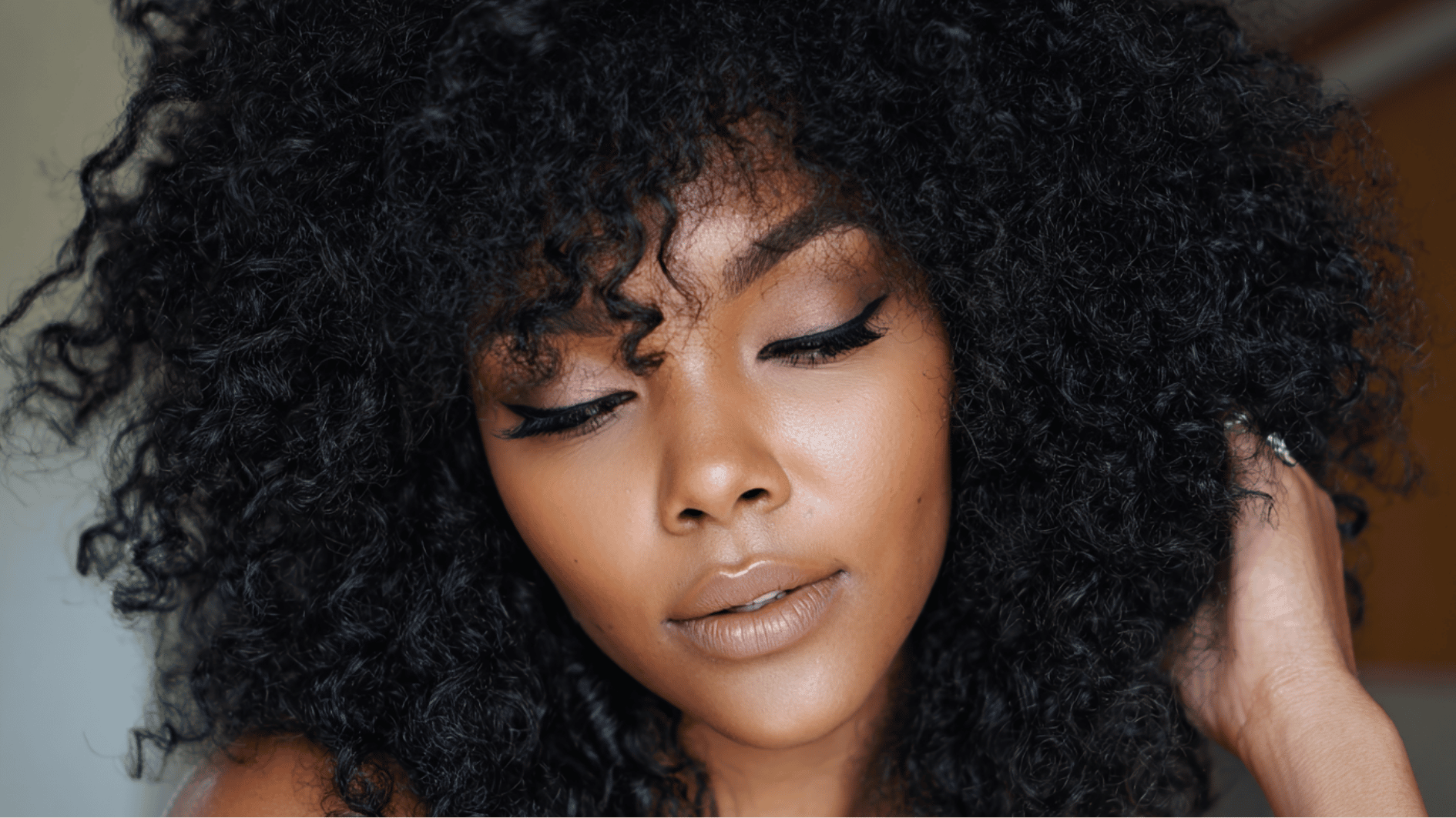kinky curly sew-in hairstyle with natural texture and full volume