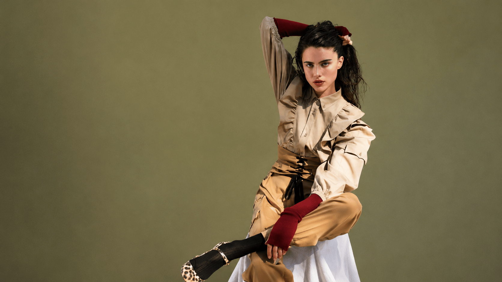 Margaret Qualley posing in beige outfit, highlighting her fashion campaigns, luxury partnerships, and modeling work