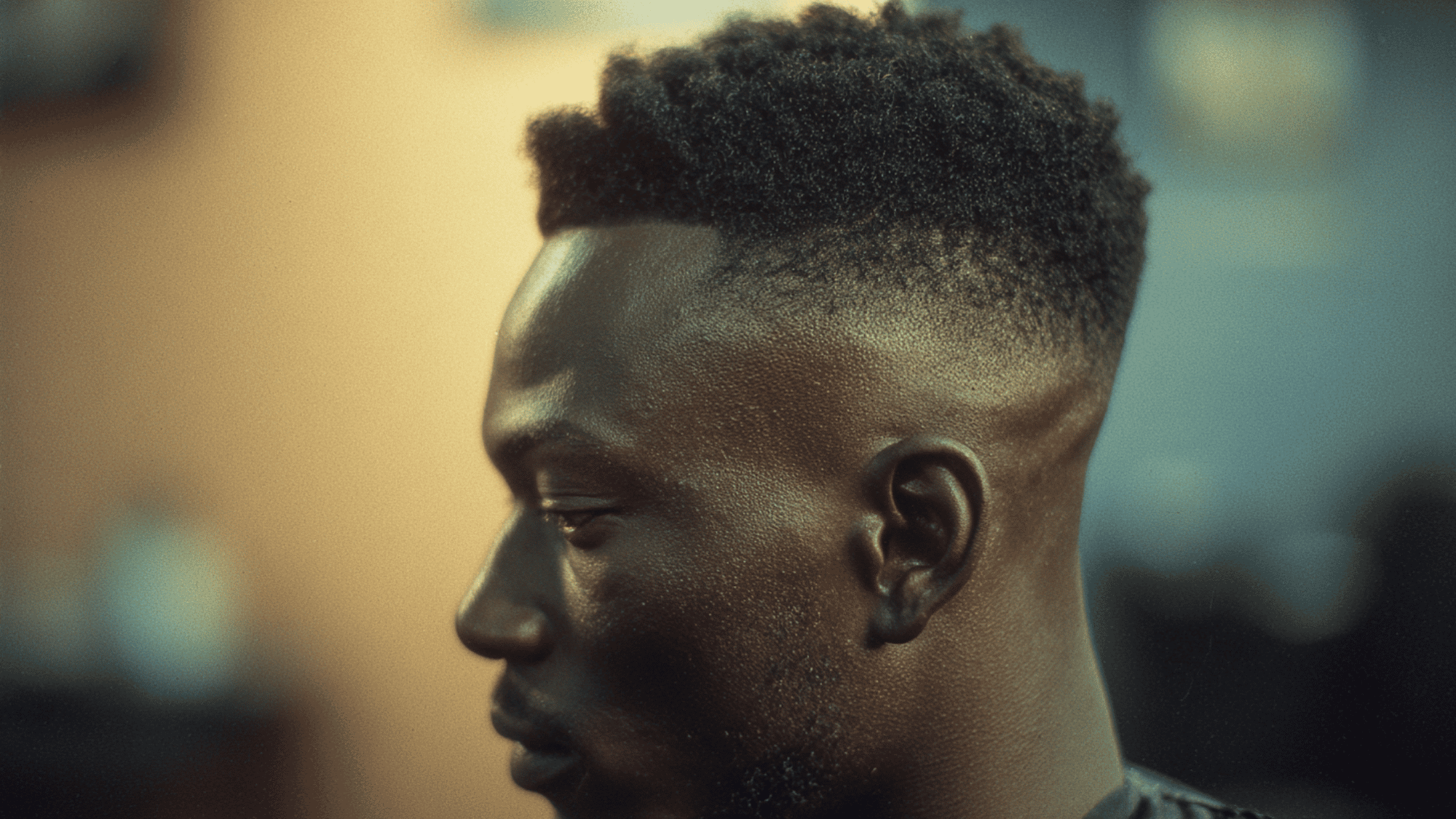 Mid fade black men defined tight coils natural top temple fade sharp line up portrait
