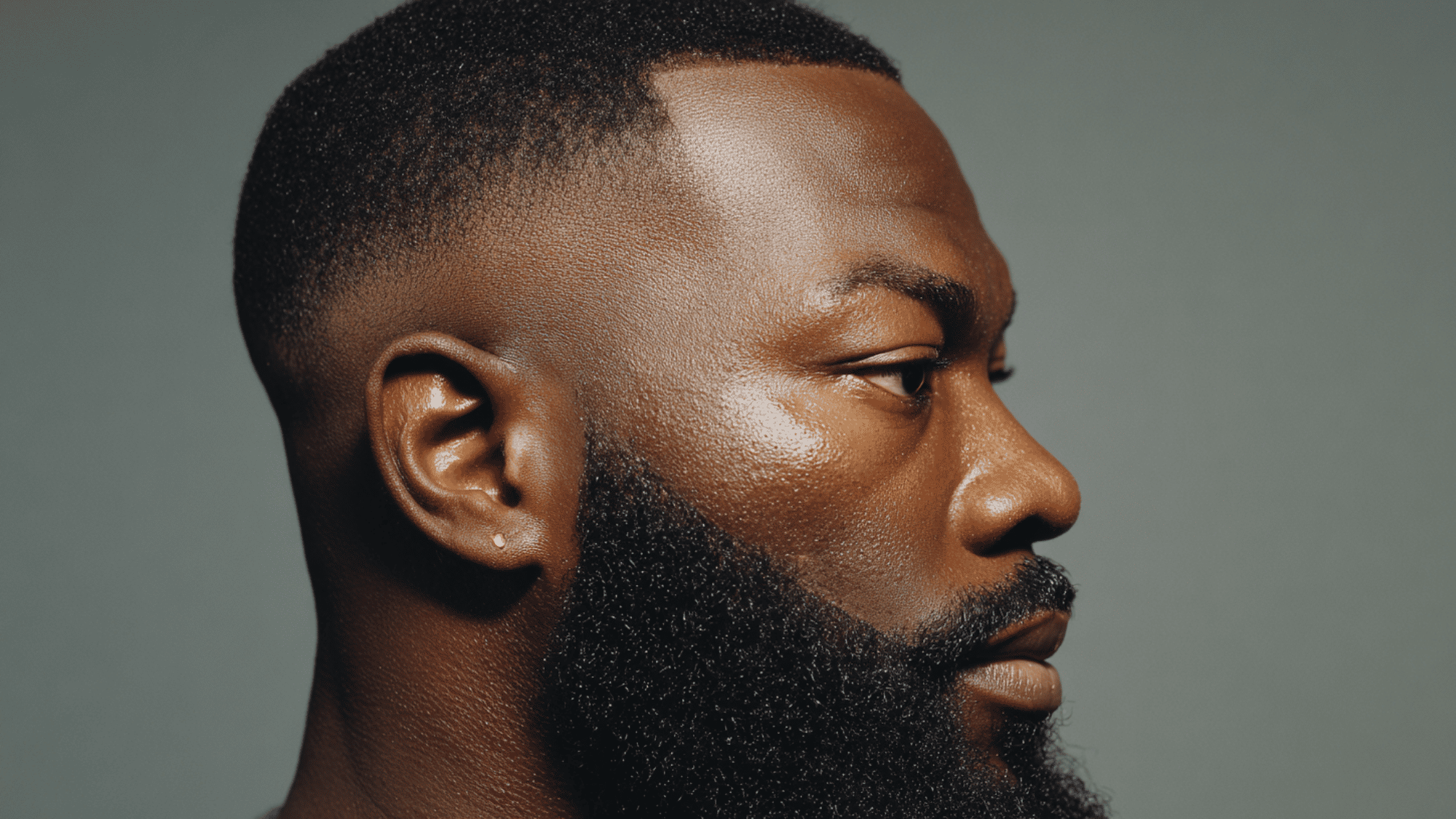 Mid fade black men taper fade connected shaped beard continuous blend jaw line portrait