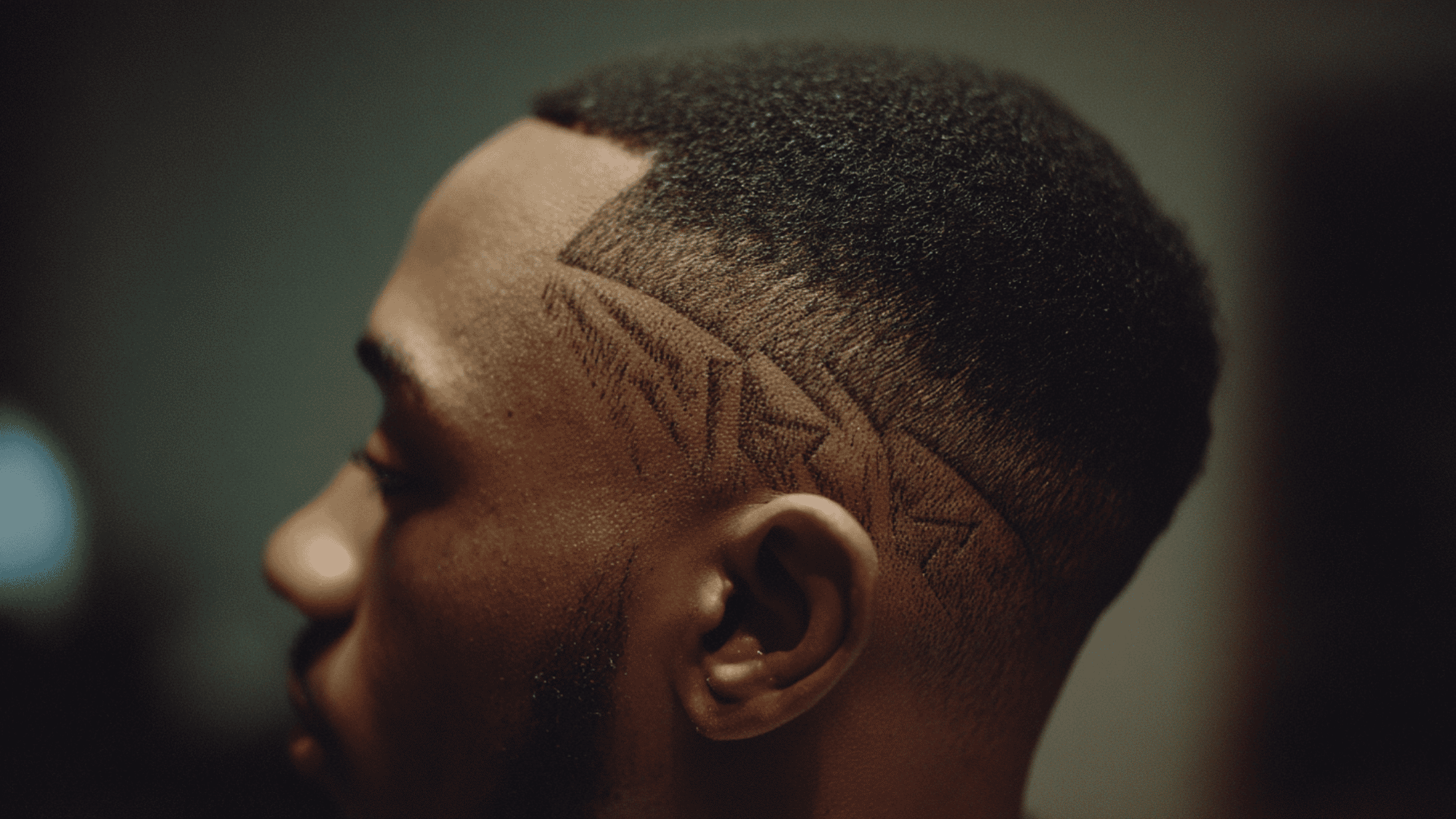 Mid fade black men temple razor cut geometric design etched hairline short top portrait