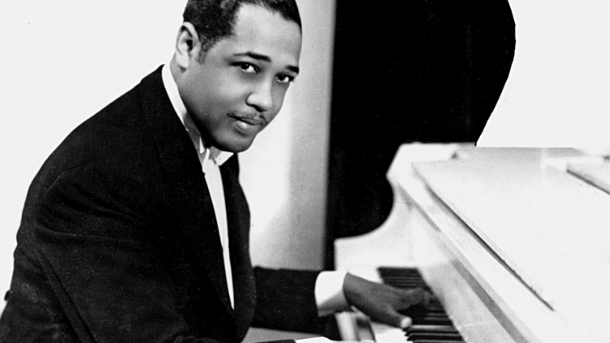 Duke Ellington Prelude to a Kiss 1938 young portrait at white grand piano black and white archival photo