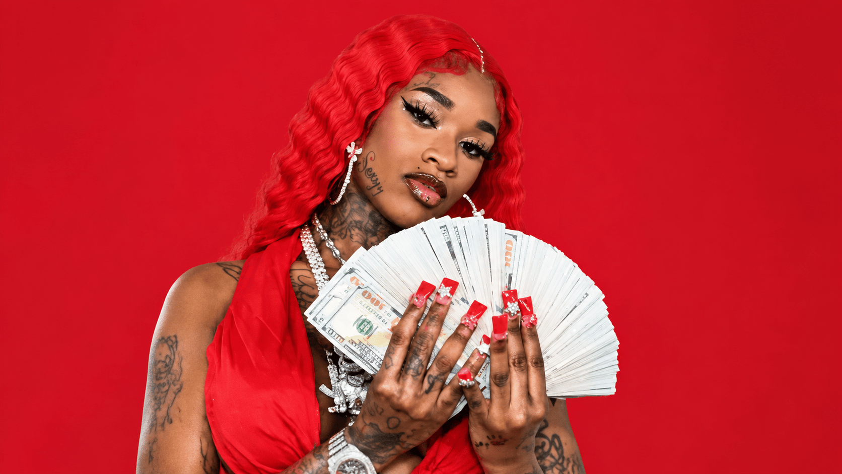 Sexxy Red showcasing her wealth and success, representing earnings from music, tours, and merchandise