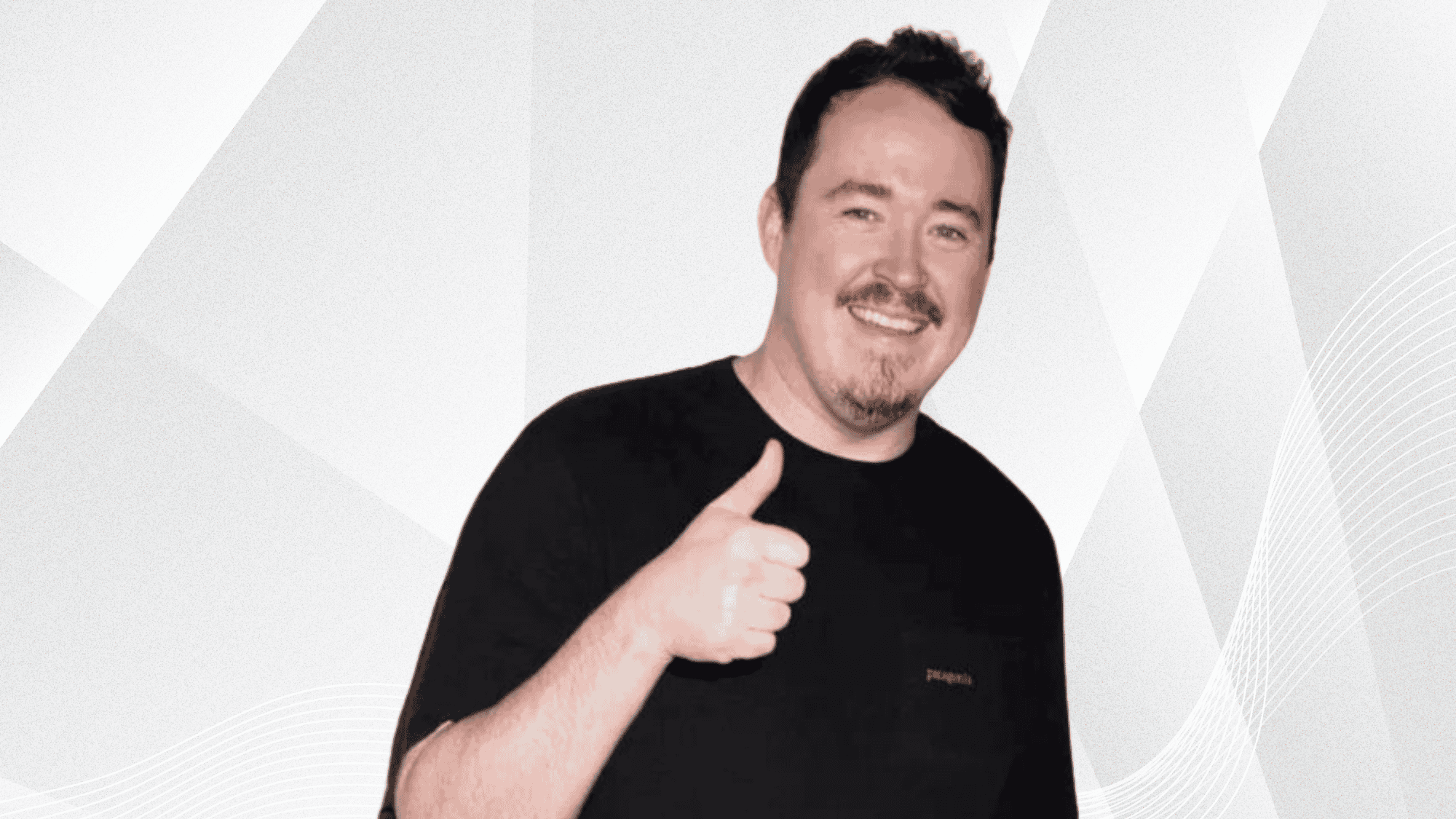 Shane Gillis smiling and giving thumbs up, highlighting his comedy career achievements