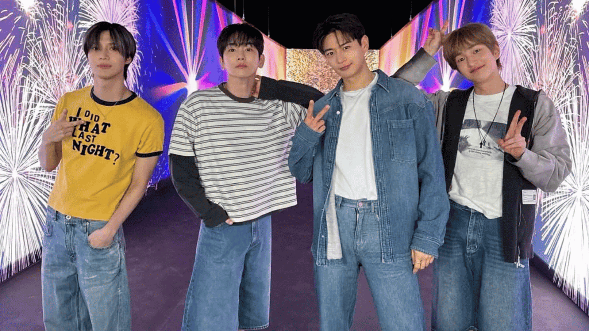 Four K-pop group members posing in casual outfits with bright concert-style lights behind them