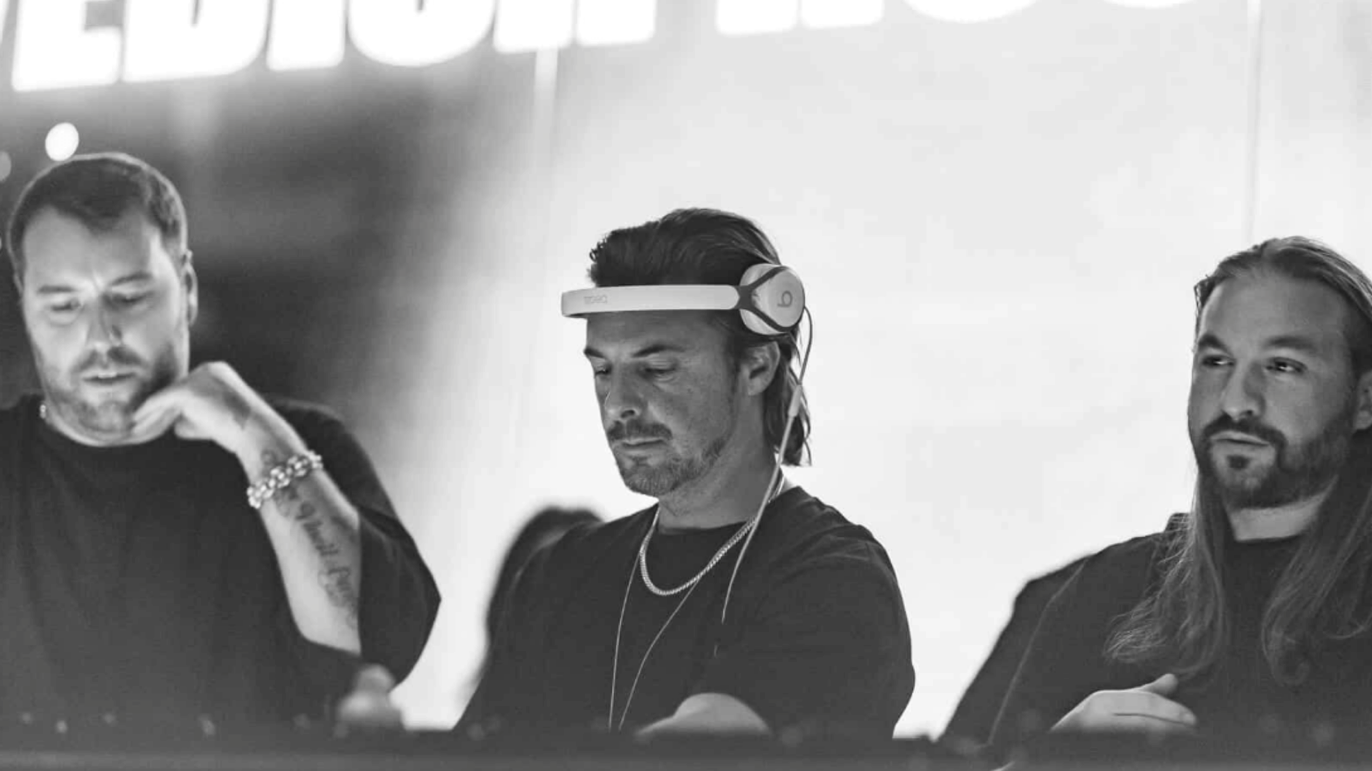 Swedish House Mafia performing on a large festival stage during their reunion tour in 2022.