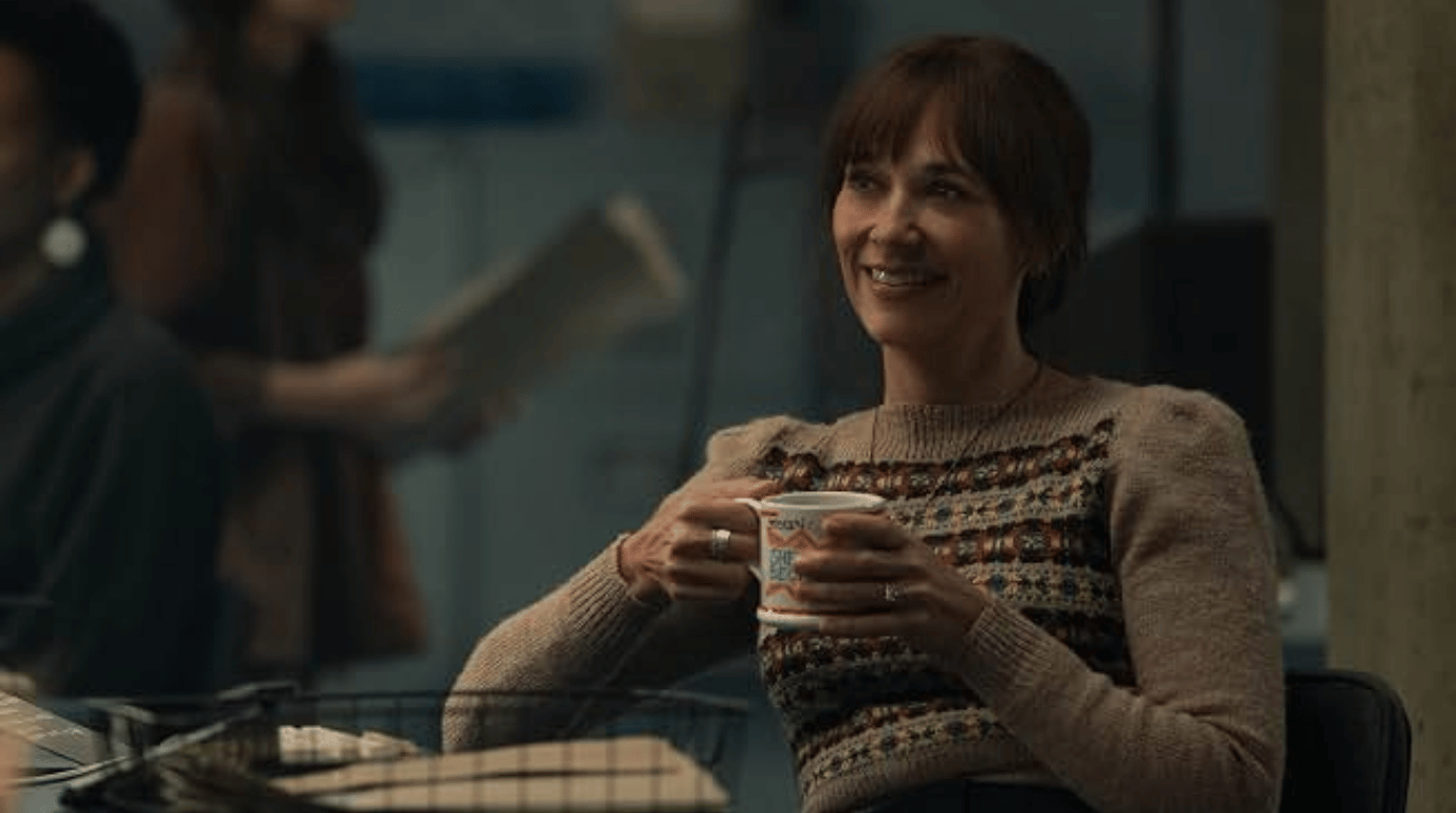 Allison Becker holding a cup in an office.