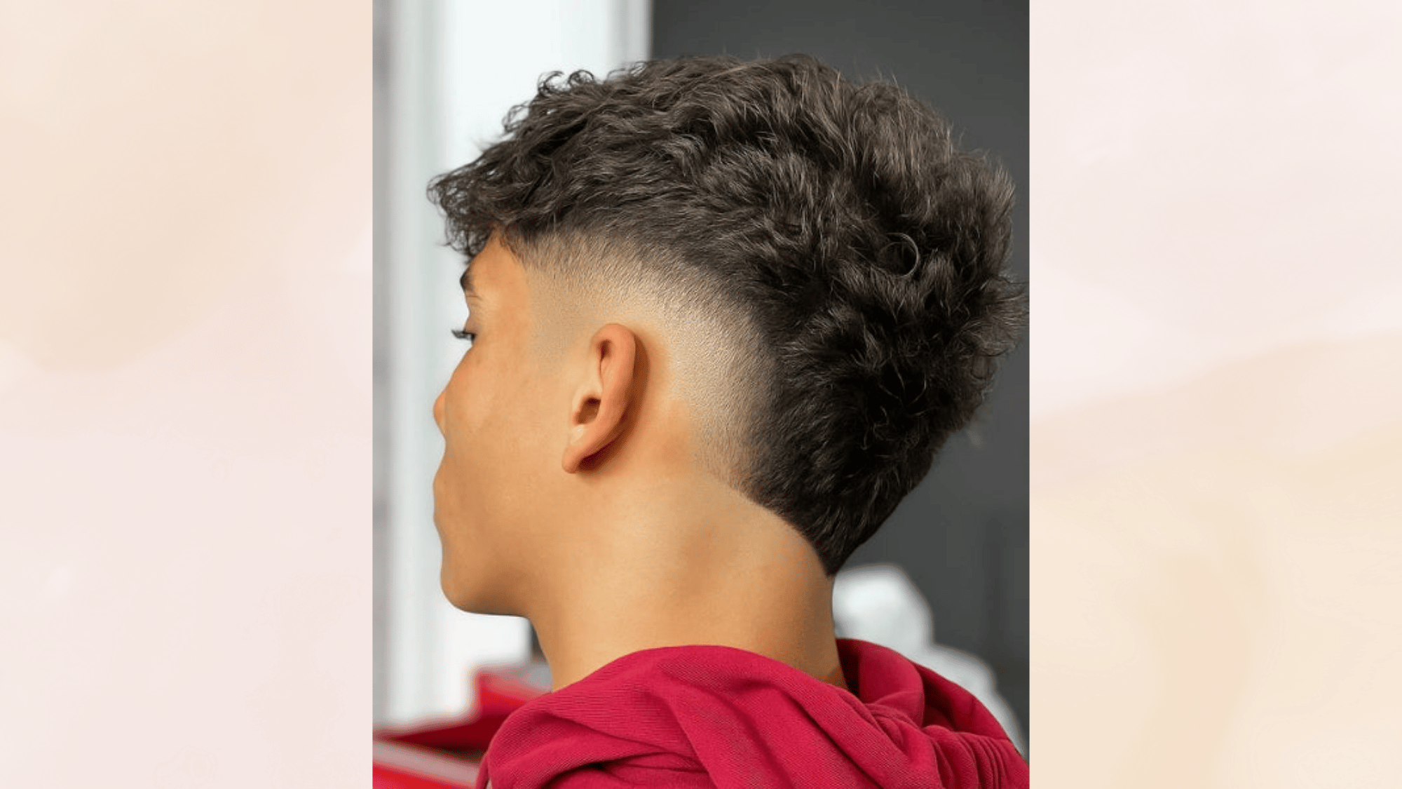 burst fade mohawk with curly textured top and tapered fade around the ears for a modern stylish look