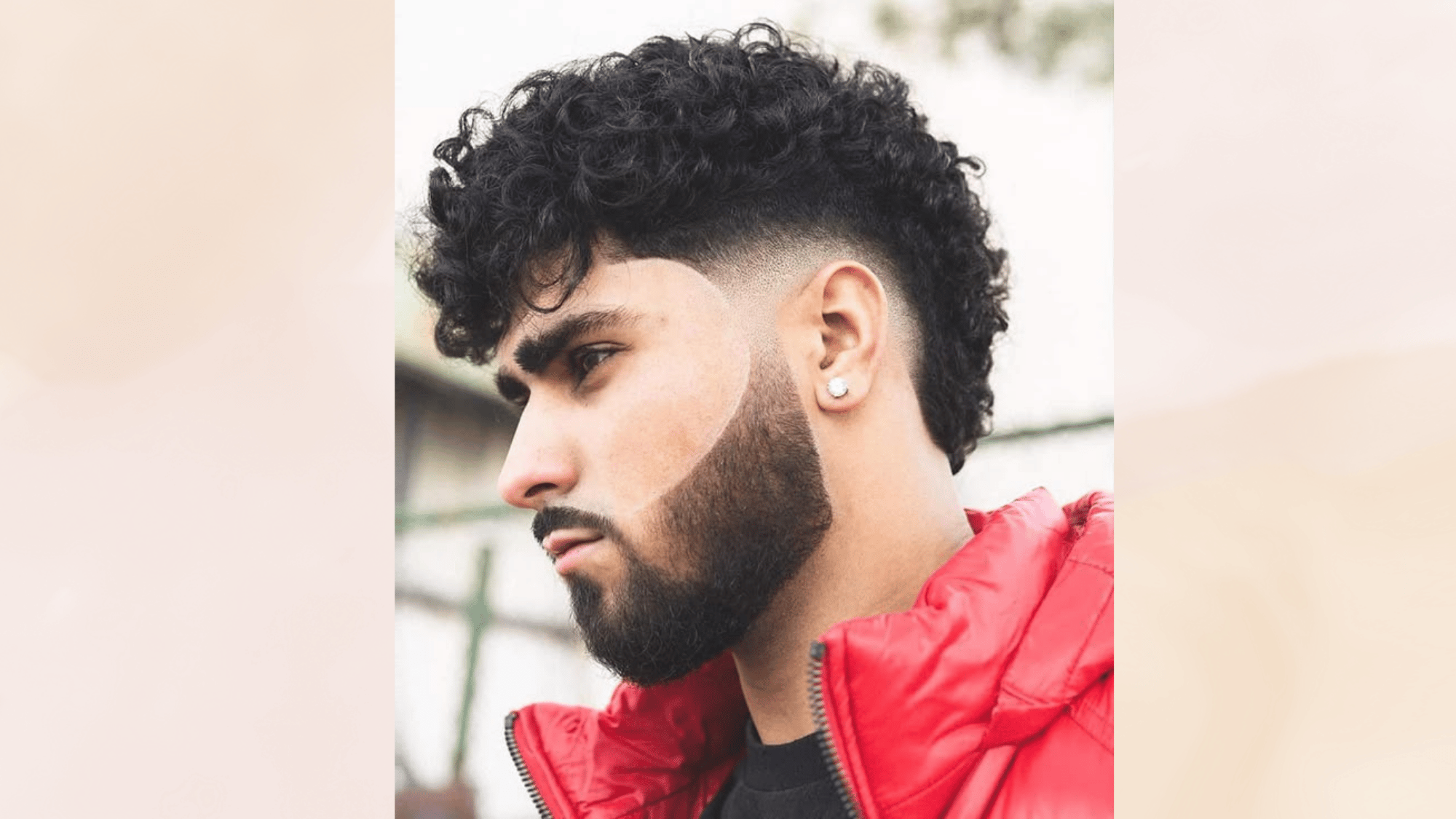 curly mohawk haircut with defined curls and faded sides creating a stylish textured and modern look