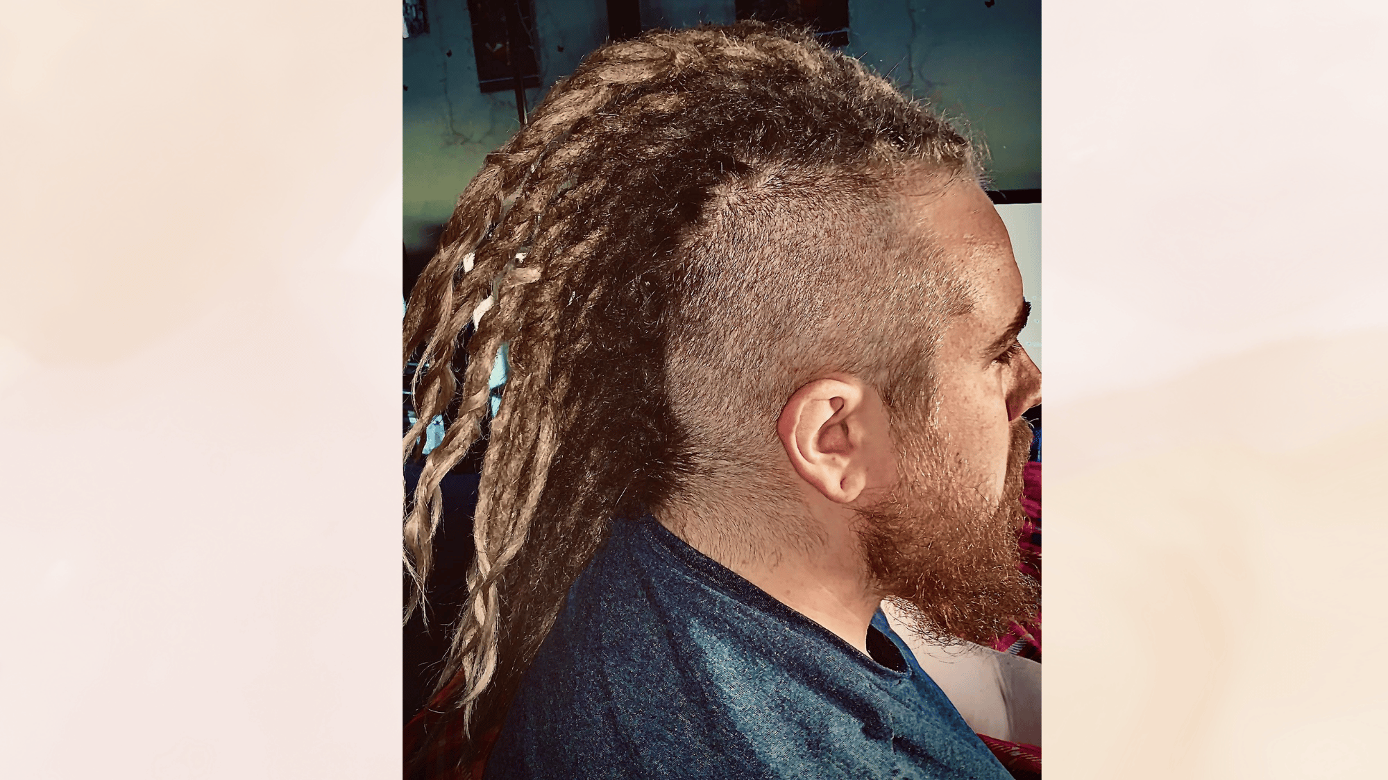 dreadhawk hairstyle with long dreadlocks and shaved sides creating a bold rugged and distinctive look