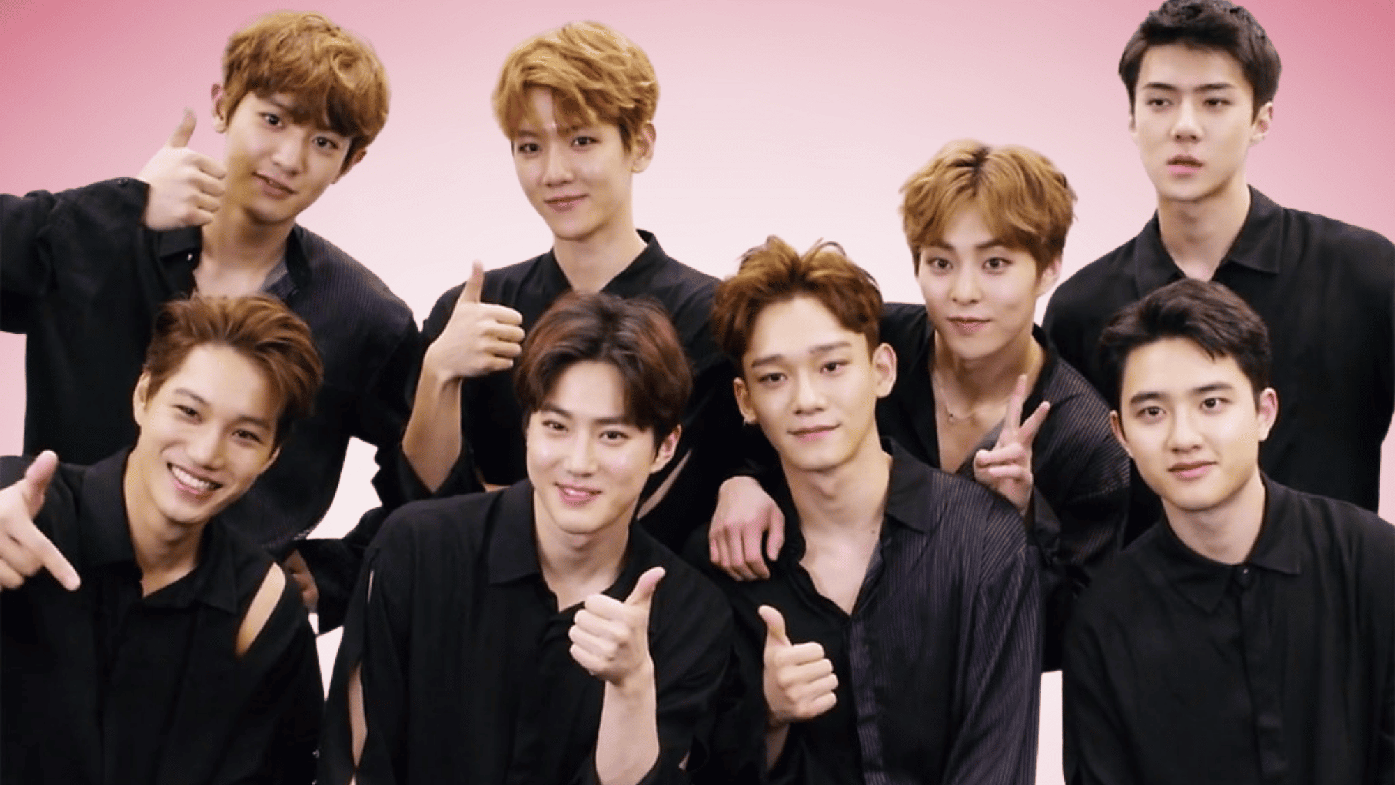 EXO members posing together, smiling during a group celebration photo.