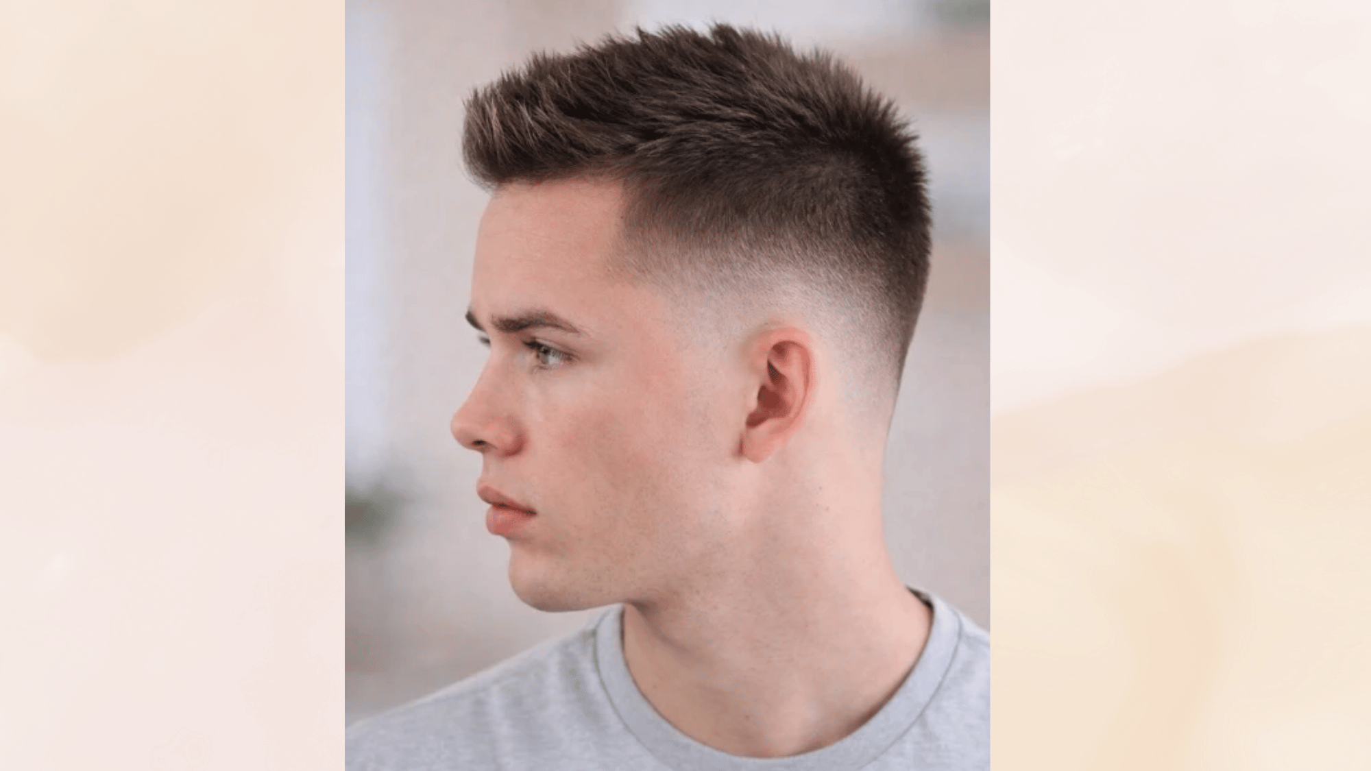 faux hawk haircut with faded sides and textured top styled upward for a modern and professional look