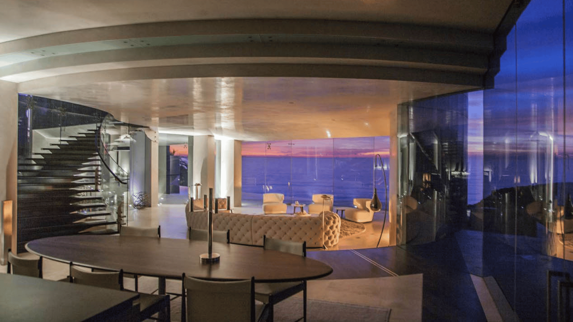 modern interior with floor to ceiling glass walls, ocean views, open living space, and futuristic mansion design inspiration