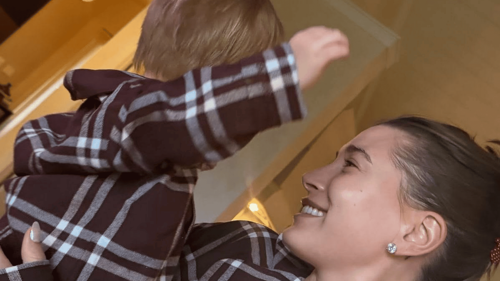 mother and toddler in matching plaid during a warm family moment