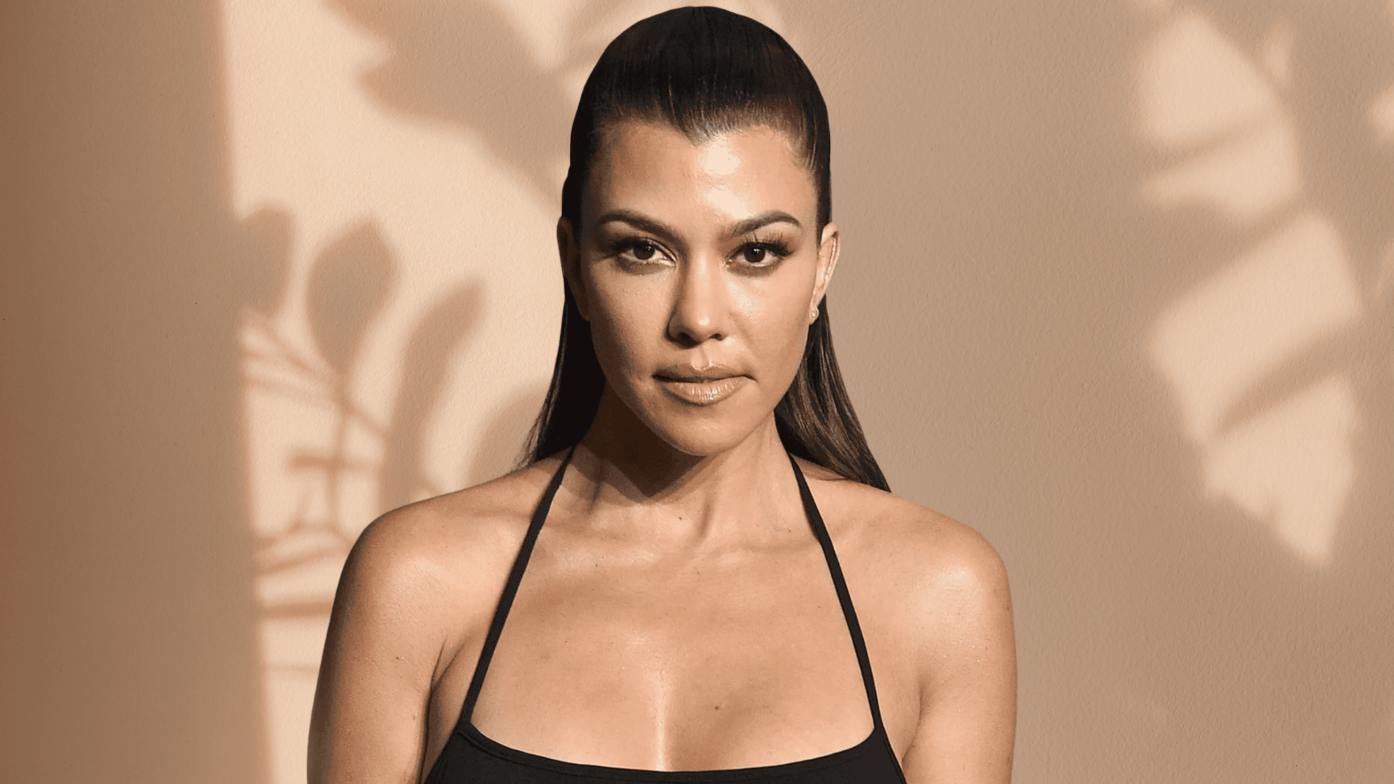 A close-up portrait of Kourtney Kardashian against a subtle background.